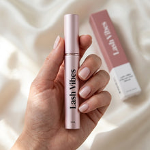 Lash Vibes eyelash serum bottle held in a hand